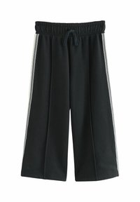Schwarze cropped Sweatpants mit elastischem Bund, Kordelzug und kontrastierenden weißen Seitenstreifen. Weiche Textur, weit geschnittenesDesign.