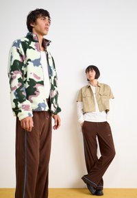 Rains ADDIS PANTS WIDE UNISEX - Tepláky - frame