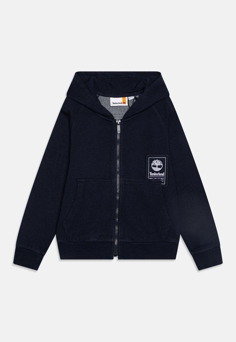 Jūras spēku kreisās puses kabatā zips ir izgatavots no kokvilnas, tam ir balts Timberland logo uzšuvums uz kreisās krūtis un ribotās aproces.