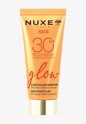 NUXE Sun Glow SPF 30 zonnige fluid met hoge UVA/UVB-bescherming en anti-aging cellulaire verzorging in een oranje en gouden tube.