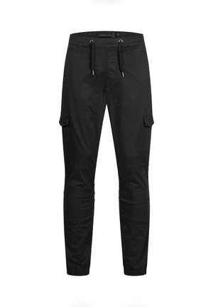 Pantalon cargo noir avec taille élastique, cordon de serrage, poches latérales à rabat, coutures aux genoux et poignets élastiques.