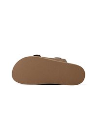 Brown rubber sandal sole with a textured surface, featuring two circular straps at the top for secure fit.