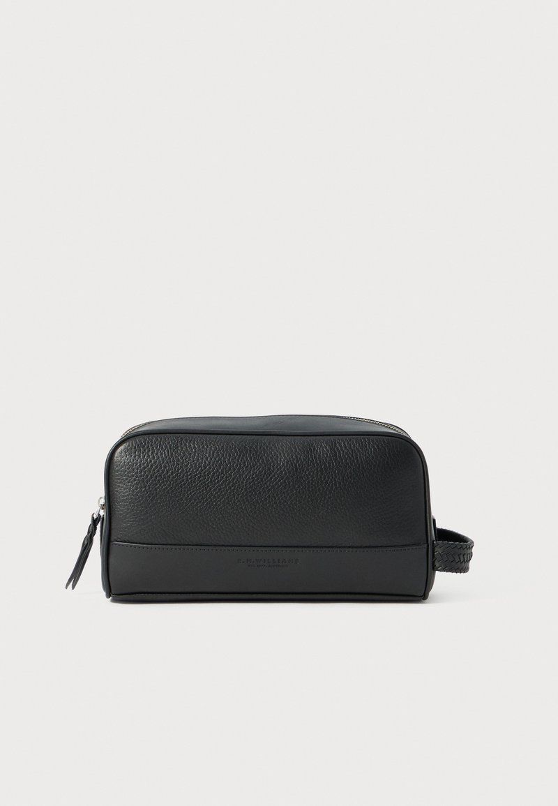 Black leather toiletry bag with a textured surface, smooth accents, zip closure, and a woven handle on one side.