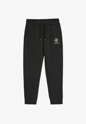 Czarne bawełniane dresy z elastycznym pasem, sznurkiem, bocznymi kieszeniami oraz haftowanym złotym logo na lewym udzie.