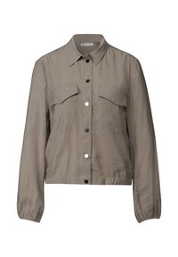 Veste taupe clair avec un col, fermeture à boutons, deux poches poitrine et poignets élastiques. Tissu lisse avec une texture légèrement brillante.