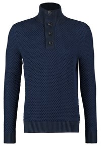 Pull en maille texturée bleu marine avec manches longues, poignets et ourlet côtelés, col montant côtelé et quatre boutons noirs sur la patte de boutonnage.