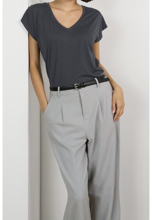 Gray V-neck t-shirt paired with light gray pleated trousers, featuring a black belt and relaxed fit. Smooth fabric with casual design elements.