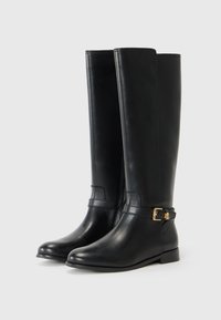 Black leather knee-high boots with a rounded toe, featuring a decorative gold buckle and a flat heel on a neutral background.