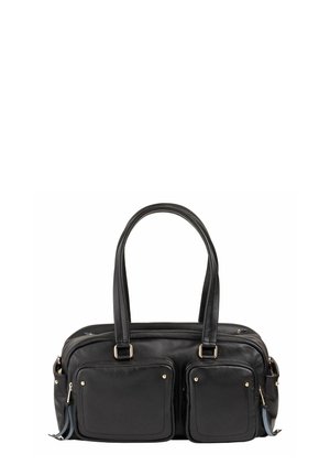 Black leather handbag with double handles, two front zip pockets with gold-tone studs, and side tassel accents against white background.