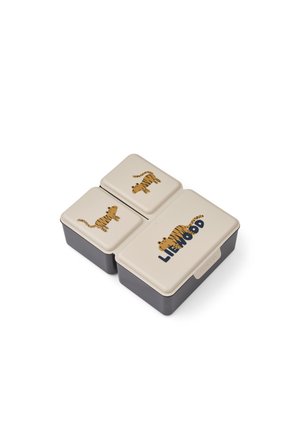 Tre indlejrede rektangulære madkasser med beige låg med tegneserie tigerillustrationer og mærket "Liewood" på det største låg.