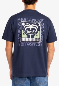 Navy blue cotton t-shirt featuring a block graphic on the back with palm trees and geometric shapes in green and white. Standard fit.