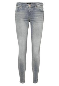Jeans ajustados en denim azul claro. Presentan bolsillos delanteros, una cremallera y un cierre de botón metálico. Degradado sutil en la textura de la tela.