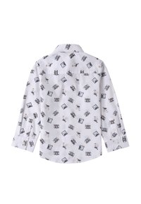 Camicia bianca a maniche lunghe con un motivo di macchine fotografiche e fotografie, realizzata in tessuto leggero, con orlo curvo e dettagli con bottoni.