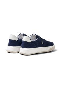 Navy blue suede sneakers with white heel accents, thick white soles, and a small metallic "B" logo on the side, shown from rear and side angles.