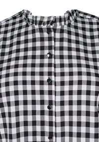 Black and white checkered blouse with a ruffled collar and front button closure. Features black buttons and a textured fabric.