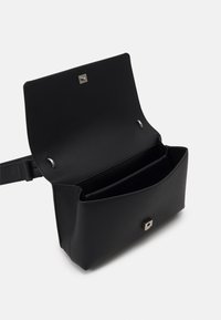 Borsa a spalla in pelle nera con forma rettangolare, dotata di chiusura con bottone magnetico e dettagli in metallo argentato. Comparto aperto visibile.