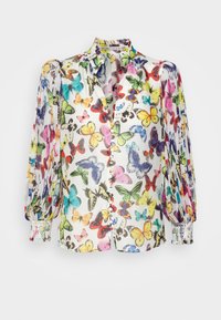 Blouse à manches longues avec imprimé papillons coloré, devant boutonné, manches plissées et poignets bordés de dentelle sur tissu blanc.