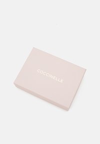 Coccinelle rectangular gift box in soft pink with a matte finish. Features a gold embossed logo on the lid. Simple and elegant design.