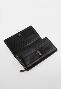 Black leather wallet with two snap closures, multiple card slots, and a clear ID window. Smooth texture with minimalist design details.