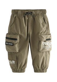 Pantaloni cargo in verde oliva, con vita elastica, cordino, molteplici tasche con zip e dettagli stampati sulle tasche delle cosce.