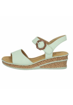 Mørkegrøn sandal med åben tå, justerbar rem og en hexagonal detaljer. Har en struktureret korkvedsål for stabilitet.