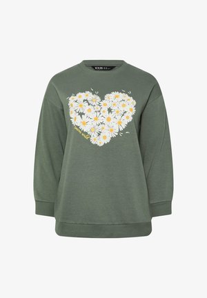 Sweat-shirt vert olive à manches longues avec un motif de cœur en marguerites blanches et jaunes et le texte "bloom wild" sur le devant.