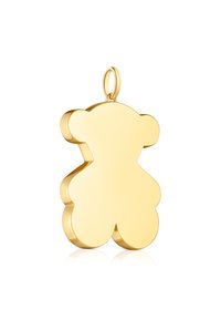 Ciondolo a forma di orsetto in oro con una superficie liscia e riflettente. Presenta bordi arrotondati e un piccolo anello per il collegamento.