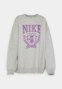 Light grey crewneck sweatshirt with purple "NIKE 1972 Oregon" text and emblem centered on the front.