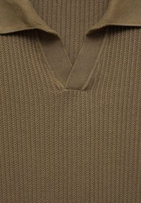 Brązowy dzianinowy polo z dekoltem w kształcie V. Teksturowana tkanina ma prążkowany wzór. Kołnierzyk jest złożony, odsłaniając strukturę dzianiny.