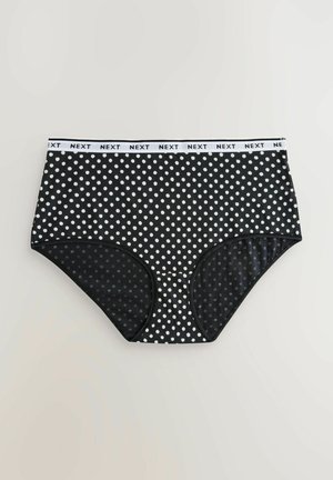 Zwarte hoogwater slips met witte polka dots, voorzien van een witte elastische tailleband met "NEXT" branding en glad, rekbaar materiaal.