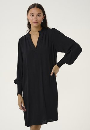 Black, long-sleeved dress with a V-neck and gathered cuffs. Made of textured fabric, knee-length with a relaxed fit and side pockets.