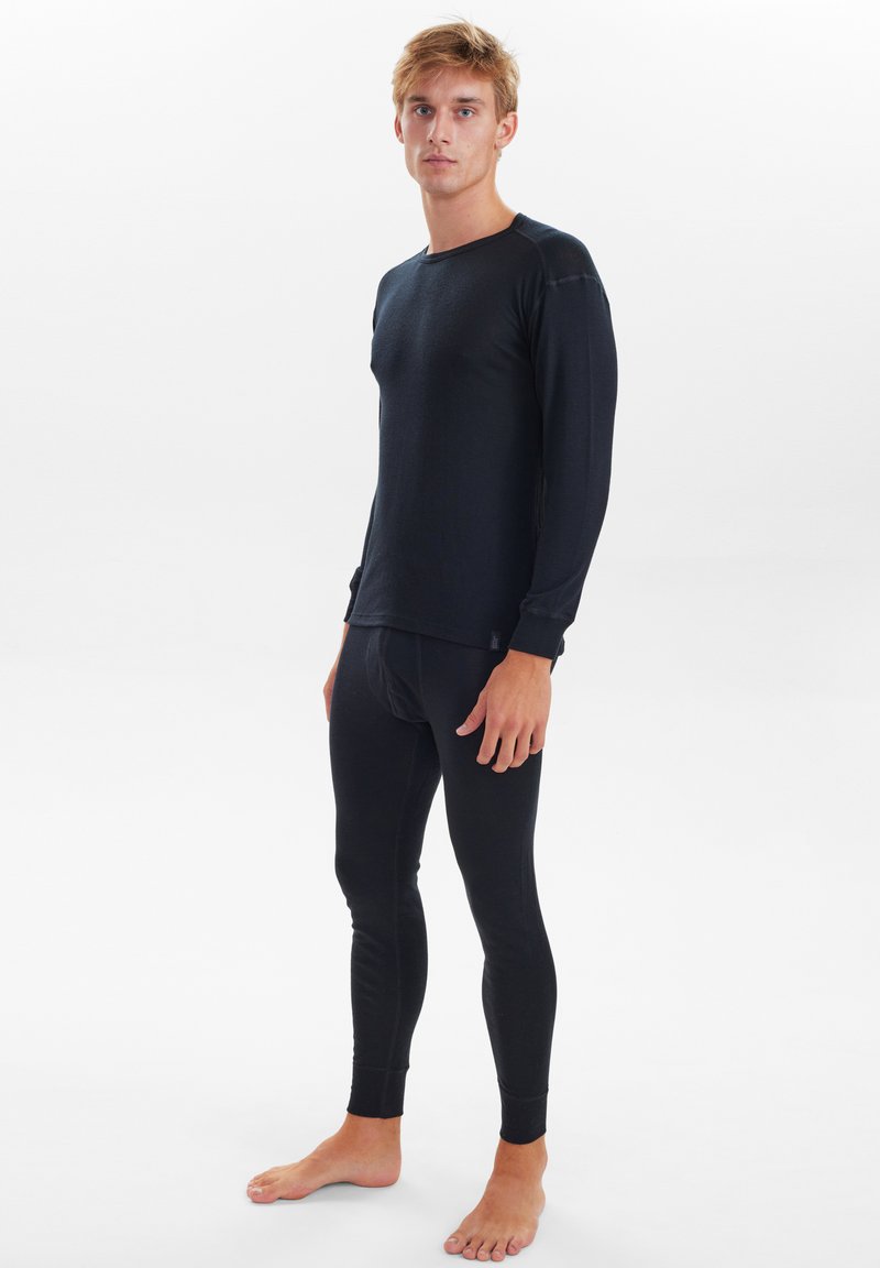 Black long-sleeve thermal top paired with black fitted leggings, made of a smooth, stretchy material. Features clean lines and fitted cuffs.