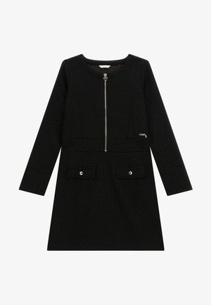 Robe noire à manches longues avec petits pois blancs, fermeture éclair à l'avant, deux poches à rabat avec boutons et détail du logo de la marque sur la poitrine.