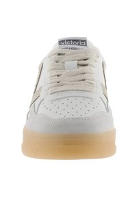 Vit sneaker med grå mockadetaljer, perforerad tåbox, beige gummisula och ljusbruna snören; logotyp på tungan.