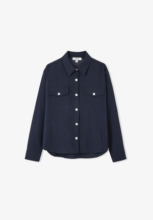Navy blue shirt jacket made from sturdy fabric, featuring a collar, two chest pockets, and silver-button closure on the front.