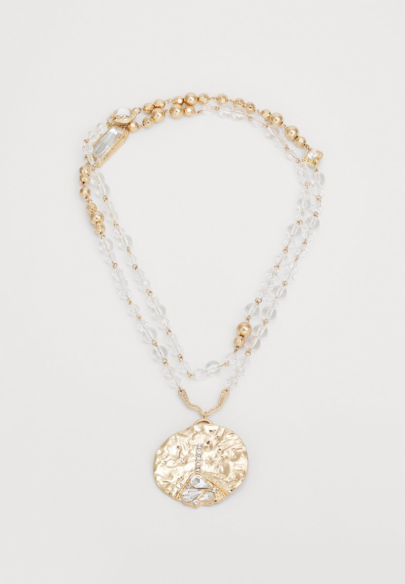 Gold-toned multi-strand necklace featuring clear beads, a textured circular pendant with a stylized Eiffel Tower, and sparkling accents.