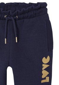 Marineblaue Sweatpants mit einem rüschierten Bund, Kordelzug und goldenem "LOVE"-Druck an der Seite. Verfügt über Seitentaschen und gerippte Akzente.