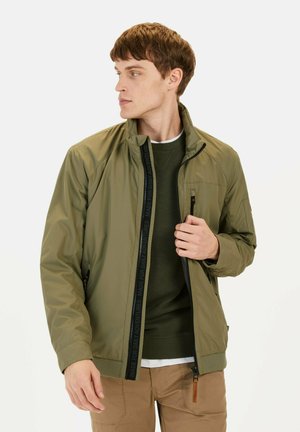 Olive green jacket with a zippered front, stand-up collar, and black accent details. Features side pockets and a smooth, lightweight texture.