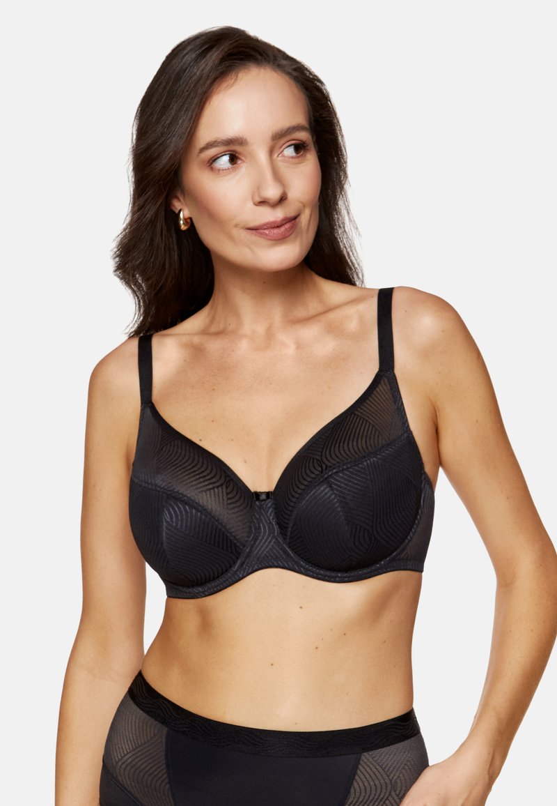 Czarny biustonosz bez drutów z teksturowanym geometrycznym wzorem, regulowanymi ramiączkami i centralnym zapięciem. Miękka tkanina o gładkim wykończeniu.