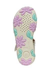 Suela de zapato infantil en color crema, con flores moradas en relieve y hojas verdes. Superficie texturizada con perforaciones. Talla marcada 27.