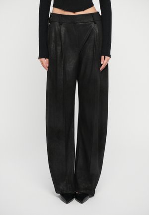 Black wide-leg trousers made from a textured material, featuring pleats, a high waist, and a decorative belt with hardware accents.