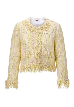 Yellow and beige textured tweed jacket with long sleeves, fringe details on collar, front edges, pockets, cuffs, and hem.