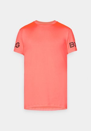 Koralle T-Shirt aus glattem Stoff. Hat kurze Ärmel und einen runden Halsausschnitt. Schwarzer Text "BYG" auf dem linken Ärmel. Einfaches, einfarbiges Design.