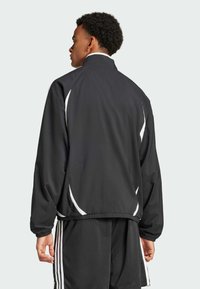Black sports jacket made of smooth fabric, featuring white accents, a stand-up collar, elastic cuffs, and a relaxed fit design.