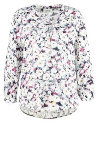 Blouse à fleurs à manches longues, base blanche, motifs floraux colorés en rose, jaune et gris. Présente une patte de boutonnage près de l'encolure.
