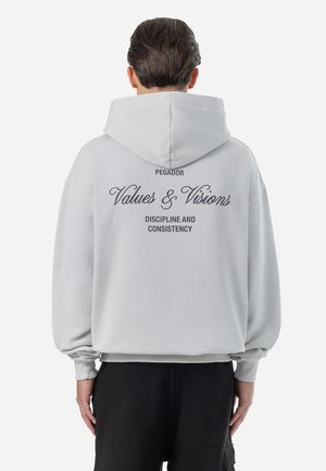 Gray hooded sweatshirt with oversized fit. Text on back includes "PEGADOR," "Values & Visions," and "Discipline and Consistency." Soft fabric.