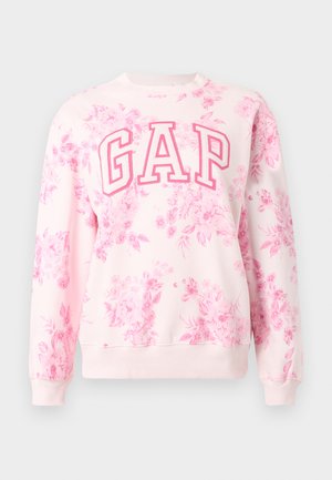 Lyserosa genser med rosa blomsterprint og store "GAP"-bokstaver brodert i mørkere rosa over brystet.