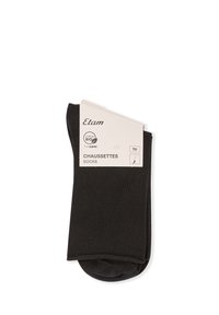 Schwarze Baumwollsocken mit glatter Textur, am oberen Ende umgeschlagen, mit einem Etikett, das nachhaltiges Material und die Größe angibt.