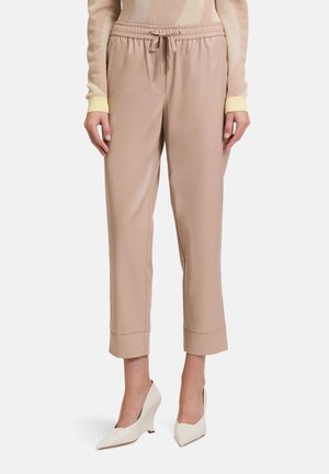 Beige, schmal zulaufende Hosen mit elastischem Bund und Kordelzug. Hergestellt aus glattem Stoff, mit umschlagenen Säumen und seitlichen Taschen.