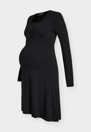 Svart langermet graviditetskjole med tettsittende overdel og vidt skjørt, designet for komfort og stil under graviditeten.